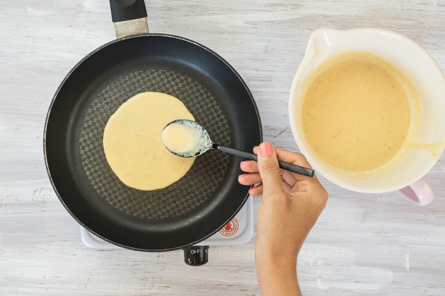 4. Schritt: Für die Tortillas jeweils zwei Esslöffel des Teiges in die heiße, leicht gefettete Pfanne geben, zu einem ca. 12 cm großen Kreis ausbreiten ...
